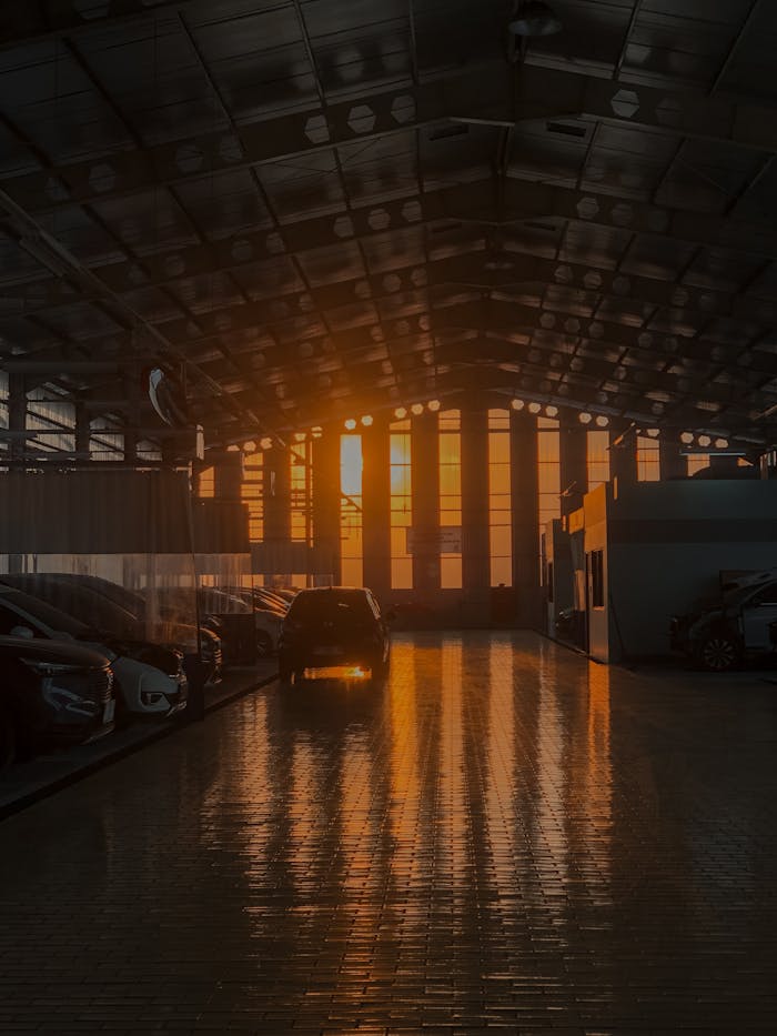 services-02 Atmospheric sunset casting reflections on a car workshop floor in Samarinda, Indonesia.